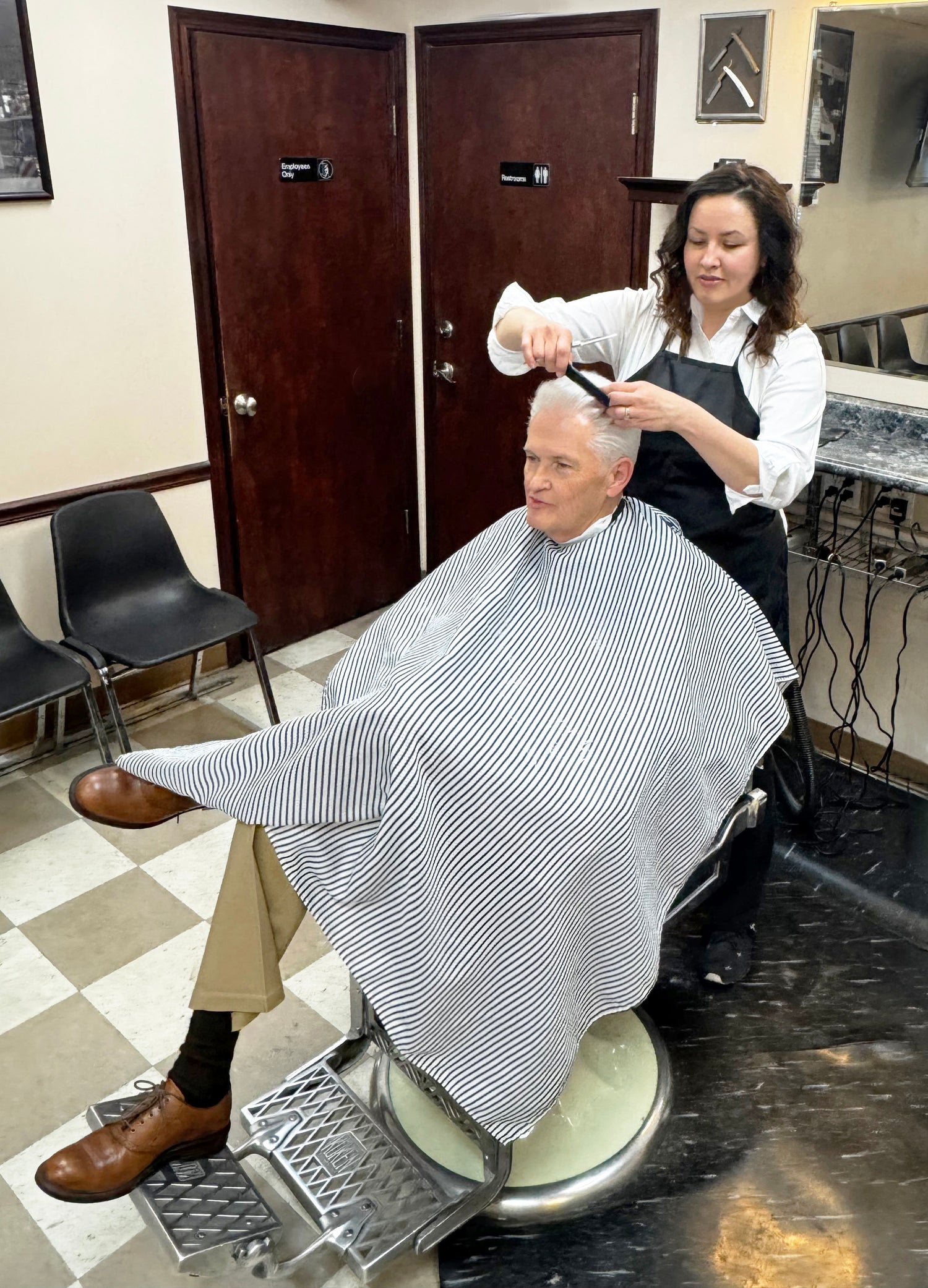 Bullseye Barbershop of Draper owned and operated by a local family. Angela giving Ron a haircut.