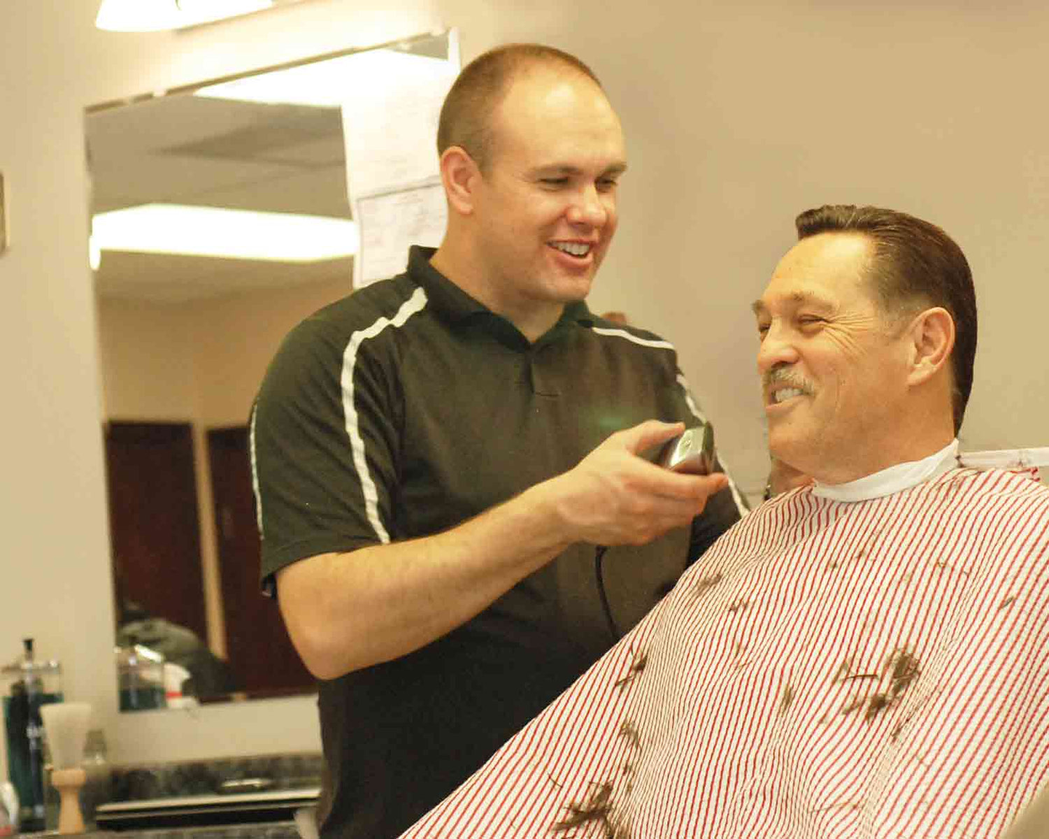 Bullseye Barbershop of Draper is owned and operated by a local family. Rick completing a traditional mens haircut and having a good laugh with a regular.